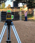 Line Laser Level Detector With Pulse Receiver for Accurate Alignment on tripod, man using rod clamp outdoors