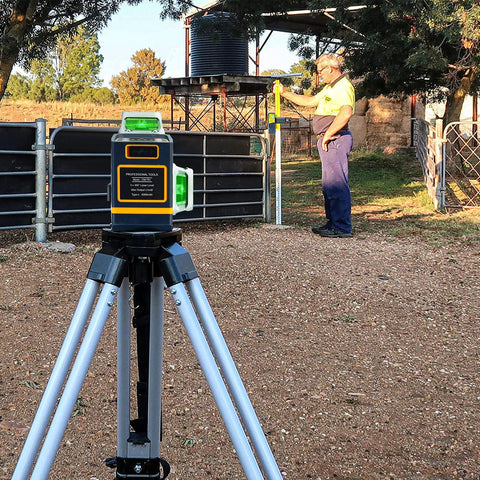 Line Laser Level Detector With Pulse Receiver for Accurate Alignment on tripod, man using rod clamp outdoors