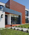 Contemporary home exterior with Matte Black Outdoor Wall Lantern With Clear Glass And LED Dimmable Lighting next to door.