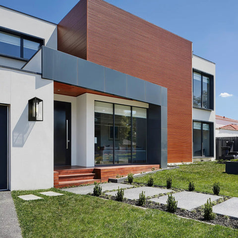 Contemporary home exterior with Matte Black Outdoor Wall Lantern With Clear Glass And LED Dimmable Lighting next to door.