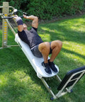 Person using EZ Curl Bar For Heavy Weight Training Fits Total Trainer Bowflex And Home Gym Cable Systems on outdoor lawn.