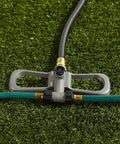 Port-A-Rain Above-Ground Sprinkler System for flexible yard watering on green grass with hoses and connectors visible