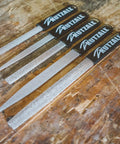 Set of coarse 8 inch half round hand rasps with ergonomic soft grip handles and tungsten carbide coating on wooden surface