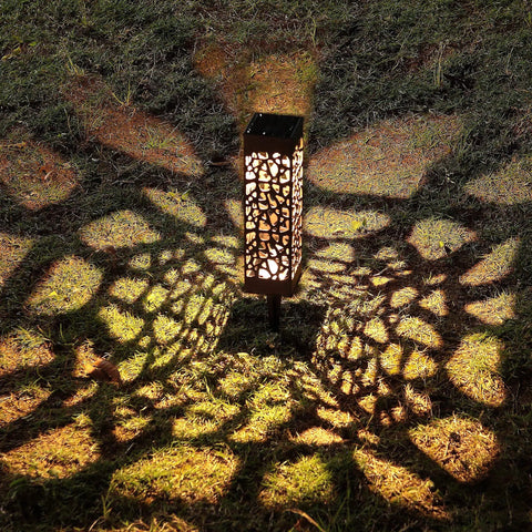 Dual Use Solar Pathway Lights Set Of 6 In Brown Stainless Steel With Warm White 8 Lumen Outdoor Garden Decorative Lighting For Walkways Patios Yards Driveways And Landscape Accents casting intricate patterns on grass at night