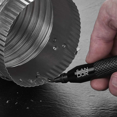 Close-up side view of a black SANDOR deburring tool with rotary shaft and replaceable blades used on metal edge.