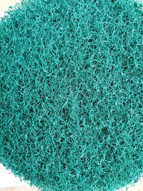 Close-up of green scrub pad from Drill Powered Tile Scrubber Kit With 4 Inch Disc Pad Holder And Six Scrub Pads, Two Stiffness Levels.