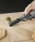 Dremel 575 right-angle attachment for rotary tools; side view of gray tool with blue accents grinding on wood.