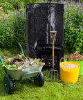 Outdoor Compost Bin For Garden 34 Gallon Reusable Yard Waste Bag alongside wheelbarrow and garden tools on grass background