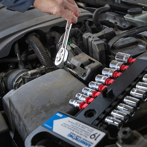 Mechanic using 19-Piece Three-Eighths Inch Drive 6 Point SAE And Metric Mechanics Tool Set for auto repair