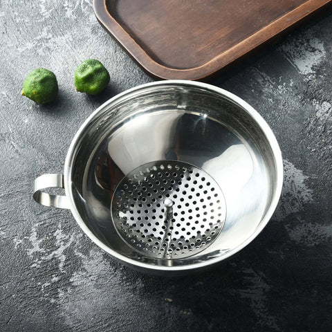Top view of stainless steel strainer from Three Piece Wide Mouth And Regular Mouth Canning Funnel Set for Mason jars on kitchen counter