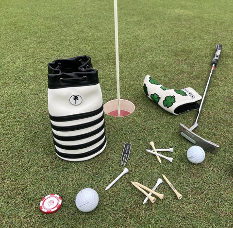 Premium Leather Golf Valuables Pouch With Drawstrings And Removable Marker on golf green with tees and balls
