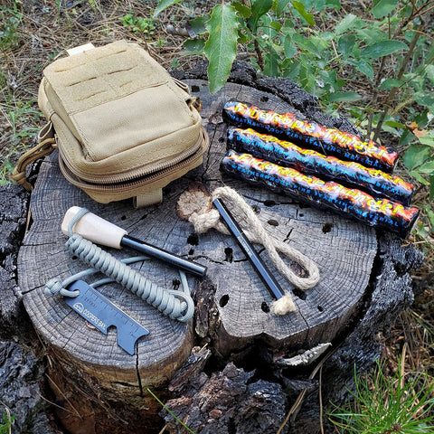 Ferro Rod Fire Starter Kit With A Large One Half Inch Rod, Fire Tinder And Custom Carry Pouch, all displayed on a tree stump.