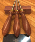 Pro Grade Cabinet Scraper Burnisher Tool With Hard Maple Handle And Super Hard High Speed Steel Rod For Card Scraper Burnishing And Woodworking Projects Made In USA, shown with wooden handles on a table.