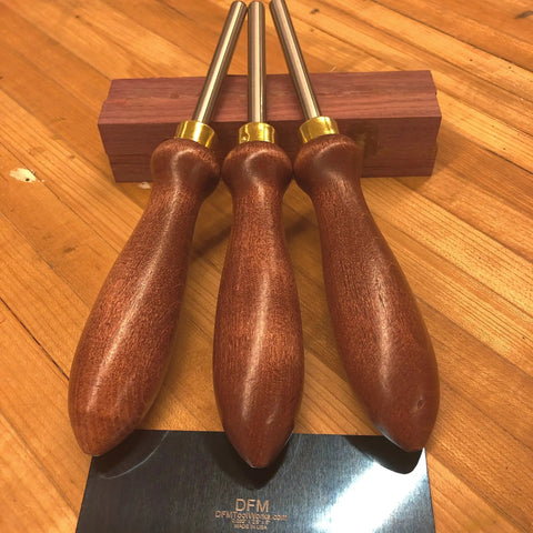 Pro Grade Cabinet Scraper Burnisher Tool With Hard Maple Handle And Super Hard High Speed Steel Rod For Card Scraper Burnishing And Woodworking Projects Made In USA, shown with wooden handles on a table.