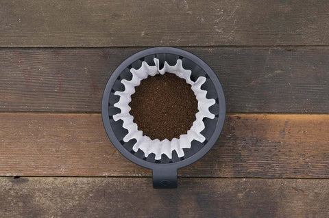 Heat N Brew 10 Cup Programmable Coffee Maker With Stainless Steel Finish, Even Brew Showerhead, coffee grounds close-up