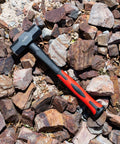 Heavy Duty Sledge Hammer 3 Lb With Shock Absorbing Fiberglass Handle And Textured Cushion Grip For Demolition Driving Stakes Concrete Breaking And Rugged Pro Work lying on rocky surface