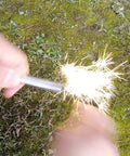 Magnesium Fire Starter Kit with Six Bags of Pure Magnesium Shavings and Ferro Rod in use on mossy ground