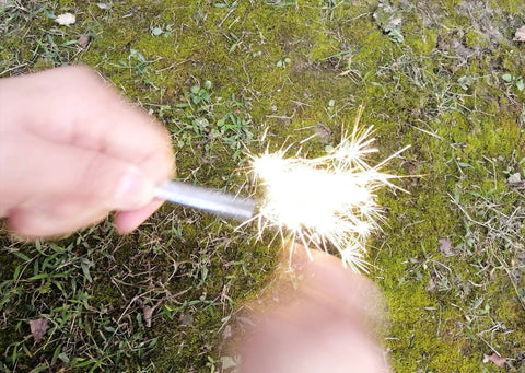 Magnesium Fire Starter Kit with Six Bags of Pure Magnesium Shavings and Ferro Rod in use on mossy ground