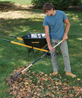 Person using Sturdy Steel Tine Leaf Rake With Hardwood And Steel Handle For Lawns And Dethatching 22 Tines 21.6 Inch Head Black