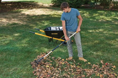 Person using Sturdy Steel Tine Leaf Rake With Hardwood And Steel Handle For Lawns And Dethatching 22 Tines 21.6 Inch Head Black