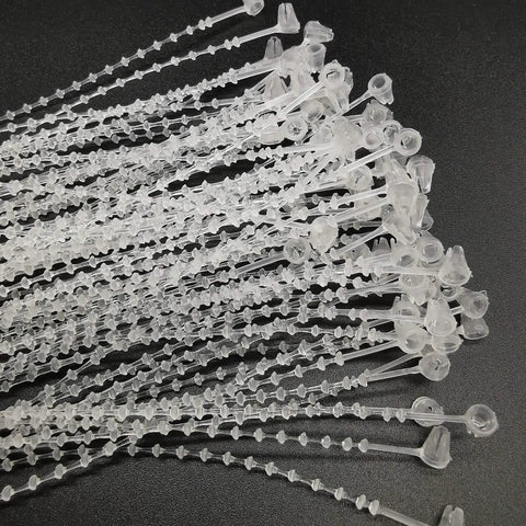 5 Inch Security Beaded Loop Ties Plastic Price Tag Fasteners Adjustable Pin Lock Merchandise Seals For Clothing Shoes And Luggage 1000 Pack White clear plastic loop ties arranged on a black background.