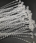 Top Shelf 7 Inch White Security Beaded Loop Ties With Extra Durable Metal Pin Breakaway Design No Sweat Snap Lock System For Retail Clothing Luggage Toys 1000 Count laid out on a dark surface.