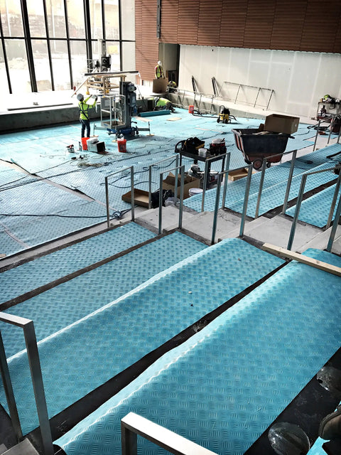 Aqua Shield Surface Protector 10 Mil 36 Inch By 100 Foot Heavy Duty Protective Film covering construction floor area indoors.