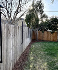 Deck Or Fence Mount For Tiki Torches And 1-1/4-Inch Poles Fits Solar Lights Black Outdoor Torch Bracket With Ground Clearance And Vertical Mount Keeps Deck Surfaces Clutter-Free installed on wooden fence.