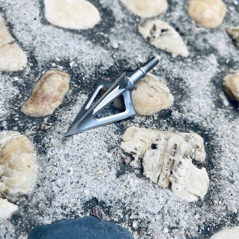 Fixed Blade Hunting Broadhead 100 Grain 420 Stainless Steel Three Razor Sharp Blades Vented Design on rocky ground