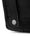Close-up of black tactical MOLLE pouch with strap and metal snap button.