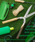 Garden tools on grass with green bottle, handheld lawn seed spreader with adjustable hole size dial lid, scissors, and rope.