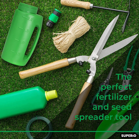 Garden tools on grass with green bottle, handheld lawn seed spreader with adjustable hole size dial lid, scissors, and rope.