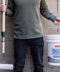 Person holding Block And Wall Liquid Rubber Waterproofer Pro Grade Multi Purpose Coating And Sealant For Concrete Walls And Foundations 1 Gallon White Made In USA Waterproof Basement Sealer bucket