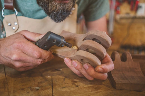 Person using Flame Rotary Burr For Wood Carving Coarse Grade One Eighth Inch Shank Tungsten Carbide Bit on wooden piece.