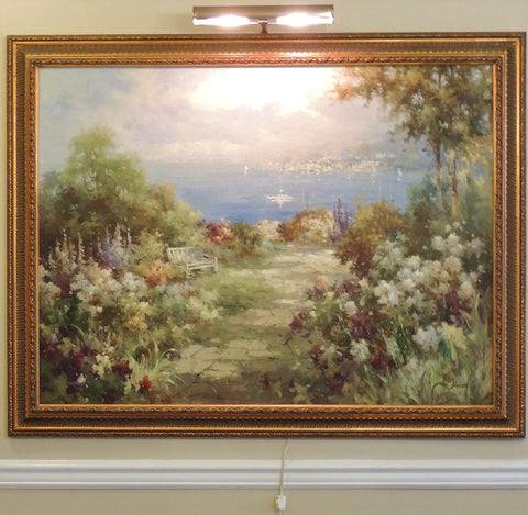 Advent 14 Inch Antique Brass Picture Light with corded on off switch illuminating framed painting on gallery wall