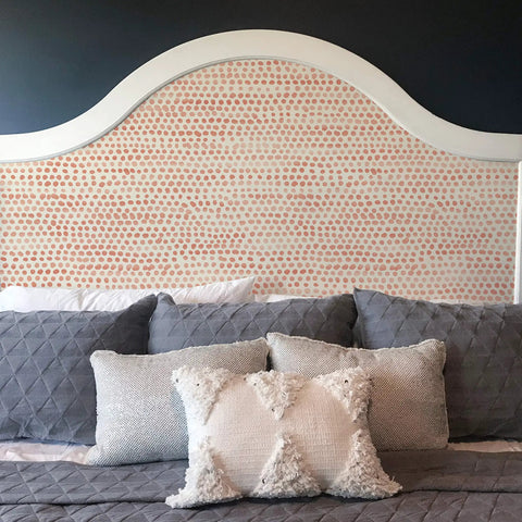 Coral Moire Dots Peel And Stick Wallpaper on headboard showing textured dot pattern for easy DIY accent walls, 20.5 In by 16.5 Ft