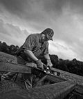 Worker using Edge Series 5 Inch Air Angle Grinder With 1.0 HP Motor Locking Lever Tease Throttle on metal beam outdoors