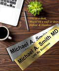 Custom Engraved Brushed Brass Office Door Name Plate And Personalized Desk Sign Featuring Sleek Metal Construction Easy Cubicle Wall Or Adhesive Mount For Bosses Crushing It Daily on a wooden desk with coffee and a laptop.