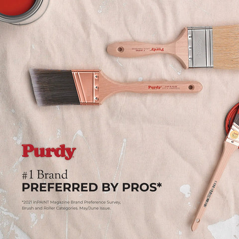 Purdy paint brushes with wooden handles on a cloth surface, ideal for precision in painting projects.
