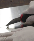 Close-up of Allway Hardened Steel Plastic Sheet Cutter With Ergonomic Design scoring a fiberglass sheet for precise cuts.