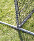 Close-up of 6Ft Black L Screen For Baseball And Softball Batting Practice With UV Treated Net And Steel Frame corner detail on grass.