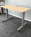 Standing desk with 2 Inch M8 Threaded PU Swivel Casters Set Of 4 With Brakes, installed on gray carpet, showcasing mobility feature.