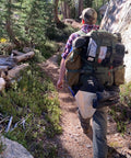 Person hiking with Water Filtration Bag For Bushcraft And Military Use, Second Edition With Taped Seams, Handmade In The UK attached.