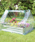 Steel Raised Garden Bed With Mini Greenhouse Cover For Outdoor Growing, featuring flowers inside clear weatherproof cover on grass.