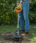 Person using 20V Cordless Garden Tiller Cultivator With 7.5 Inch Width, 6 Inch Depth, 4 Steel Tines in a garden