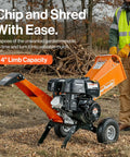 4-Inch Wood Chipper Shredder Mulcher, 9HP Gas-Powered Heavy Duty Chipping Machine in use by man, outdoors with leaves.