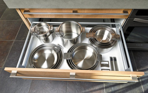 Open drawer with PSX Strate Handle Set For Cookware, removable oven-safe stainless steel handles, and stackable pans.