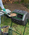 Mr Spin Compost Tumbler With Dual Chamber Design 160 Liter 43 Gallon Capacity Two Leg Stand Green And Black in use outdoors.