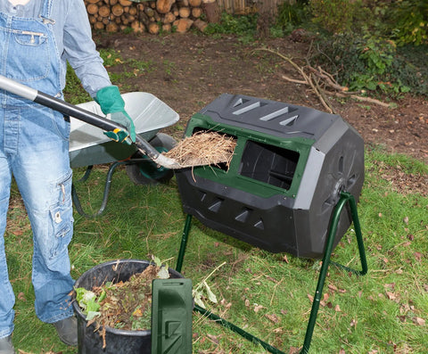 Mr Spin Compost Tumbler With Dual Chamber Design 160 Liter 43 Gallon Capacity Two Leg Stand Green And Black in use outdoors.