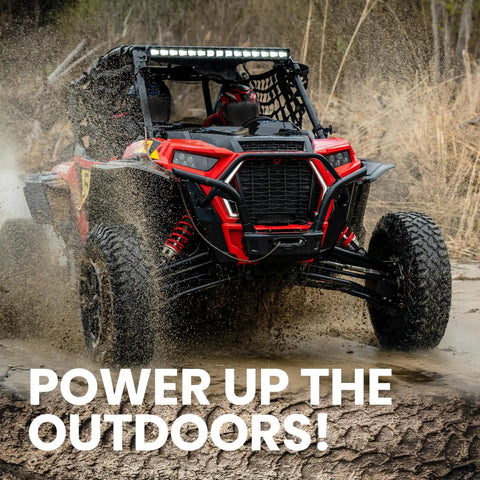 Off-road vehicle driving through muddy terrain with text 'Power Up the Outdoors' displayed at the bottom.
